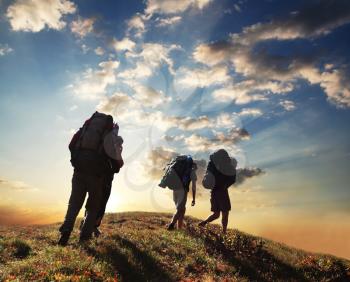 Royalty Free Photo of Backpackers on a Hill at Sunset