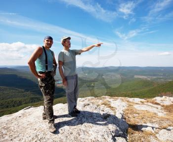 Royalty Free Photo of Two Men on a Cliff