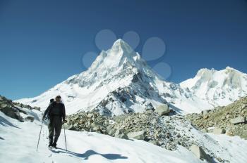 Royalty Free Photo of a Hiker in the Snowy Himalayan Mountains