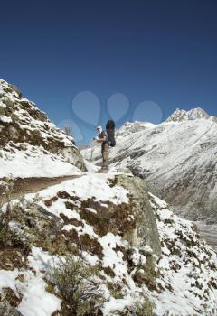 Royalty Free Photo of a Backpacker on a Snow Covered Hill