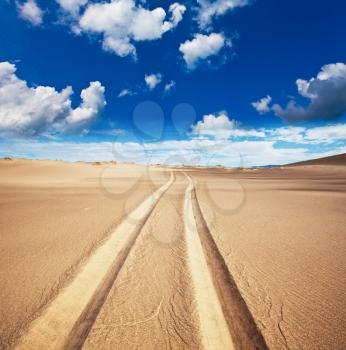 Royalty Free Photo of Tire Tracks in the Desert