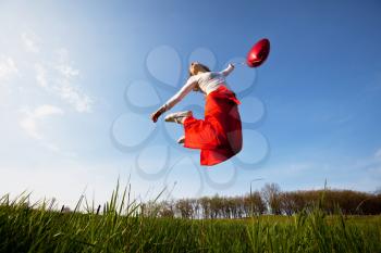 Royalty Free Photo of a Woman Jumping in a Field