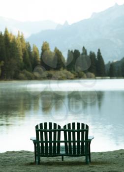 Royalty Free Photo of Chairs by a Lake