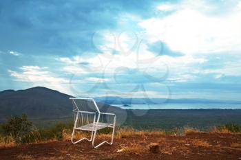 Royalty Free Photo of a Chair Overlooking an African Lake