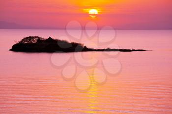 Royalty Free Photo of a Sunset Over a Lake and Island