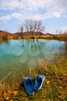 Royalty Free Photo of a Lake and Sandals