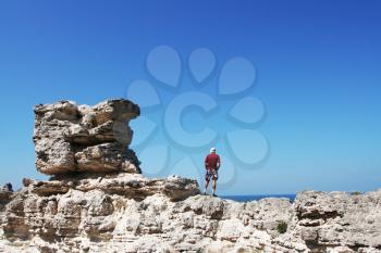 Royalty Free Photo of a Man Standing on a Rock