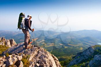 Royalty Free Photo of a Backpacker Standing on a Cliff