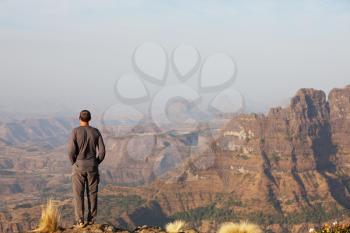 Royalty Free Photo of a Man Standing on a Cliff