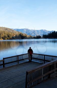 Royalty Free Photo of a Man Looking at a Lake 