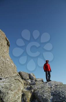 Royalty Free Photo of a Man Standing on Rocks in the Crimean Mountains