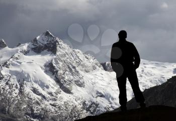 Royalty Free Photo of a Silhouette of a Man Looking at the Cordillera Mountains