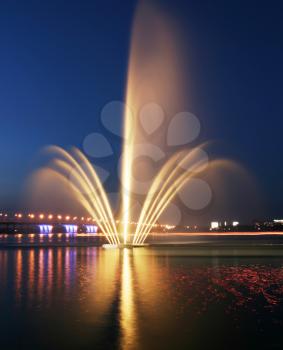 Royalty Free Photo of a Fountain on a River at Night
