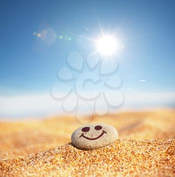 Royalty Free Photo of a Happy Face on a PEbble