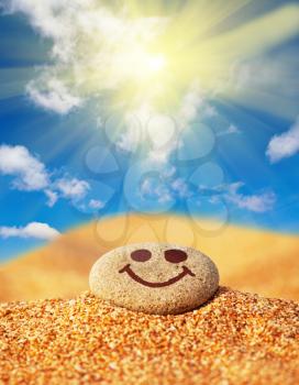 Royalty Free Photo of a Happy Face on a Pebble