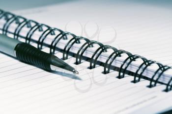 Royalty Free Photo of a Pen Laying on a Notebook