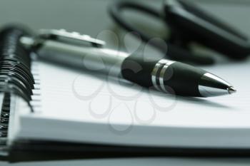 Royalty Free Photo of a Pen Laying on a Notebook