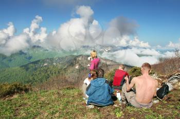 Royalty Free Photo of People Sitting on a Mountain