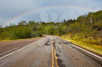 Royalty Free Photo of a Rainbow Over a Road
