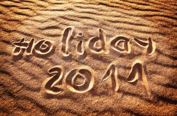 Royalty Free Photo of the Words Holiday 2011 Written in the Sand