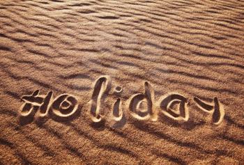Royalty Free Photo of the Word Holiday Written in the Sand