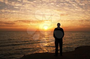 Royalty Free Photo of a Man Watching a Sunset