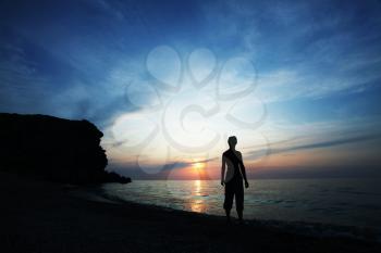 Royalty Free Photo of a Silhouette of a Person Watching a Sunset