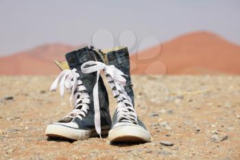 Royalty Free Photo of Denim Shoes in the Desert