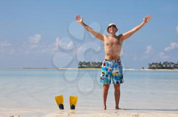 Royalty Free Photo of a Man at the Beach with Flippers