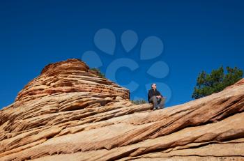 Royalty Free Photo of a Man Resting on a Cliff in Zion National Park