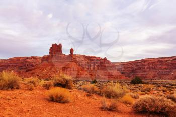 Valley of the Gods rock formation with Monument Valley at sunrise