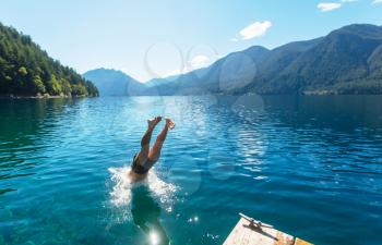 Man jumping in Crescent lake,Olympic National Park,Washington, USA