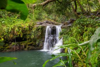 Beautiful waterfall in tropical rainforest in Hawaii island, USA