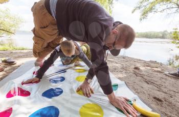 Kids playing twister game outdoors
