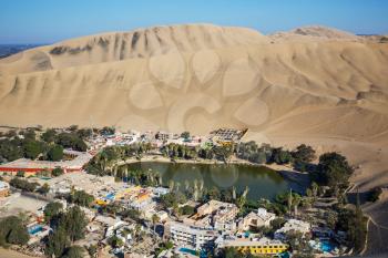 Huacachina Oasis, in the desert sand dunes near the city of Ica, Peru, South America. Unusual landscapes.