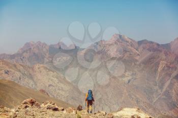 Wanderlust time. Man hiking in beautiful Fann mountains in Pamir, Tajikistan. Central Asia.