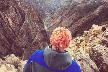 Tourist on the granite cliffs of the Black Canyon of the Gunnison, Colorado, USA
