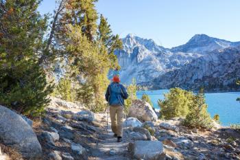 Man with hiking equipment walking in Sierra Nevada mountains, California, USA