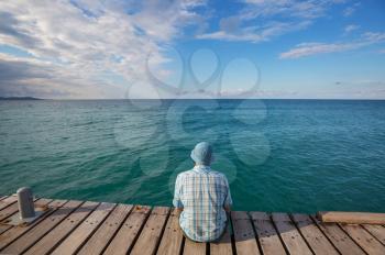 Man relaxing on sea pier 