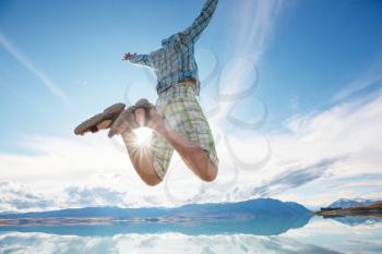 Jumping man in blue sky