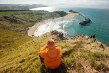Man overviews beautiful landscapes it the Ocean Beach, New Zealand. Inspiring natural and travel background
