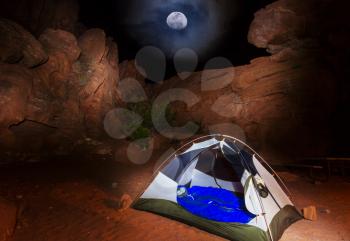 Amazing scene in night camping. Tent among the beautiful rocks.