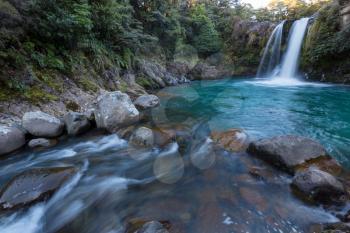 beautiful waterfall in green rainforest, New Zealand