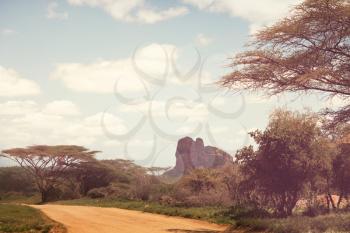 Safari and extreme travel in Africa. Drought  mountain landscape with dust off road in offroad car expedition.