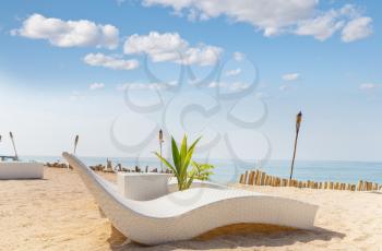 Luxury chairs on a sandy beach in ocean coast. Holiday and vacation concept. Tropical beach.