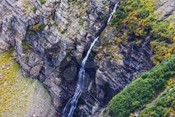 Waterfall in Galacier National Park, Montana, USA. Autumn season.