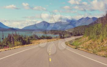 Scenic road in the mountains. Travel background. Vintage filter.