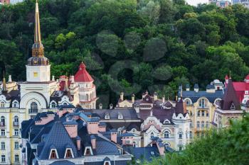 Kiev city. Old town. Ukraine. Beautiful view of the ancient street Andrew's Descent and the St. Andrew's Church among green trees of the Castle Hill in Kyiv