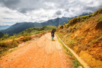 Hmong woman are on a way from their village to Sapa, Vietnam.