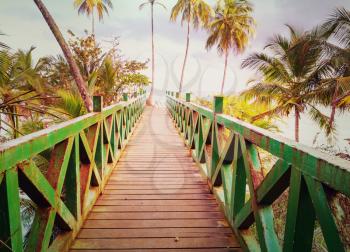 Wooden boardwalk on the tropical beach